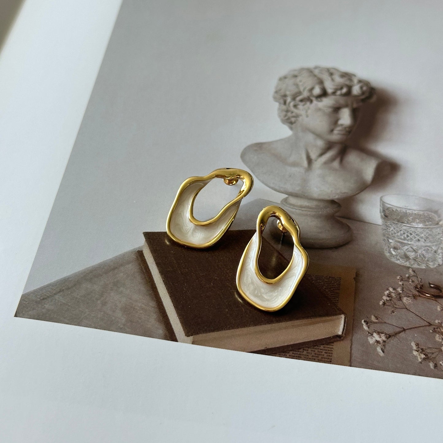 White and gold enamel irregular hoop earrings
