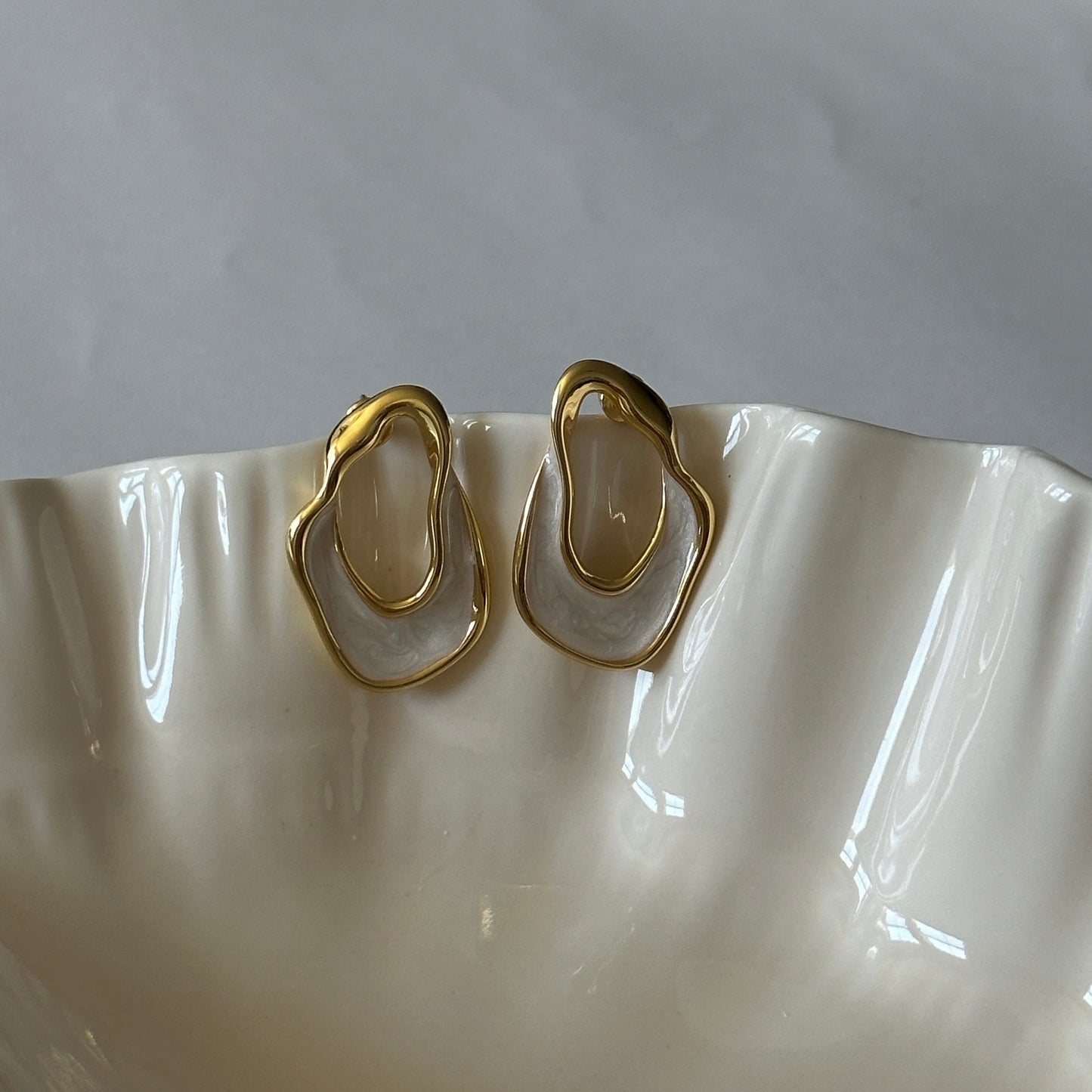 White and gold enamel irregular hoop earrings